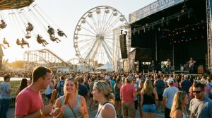 Crowds enjoying live music and rides at the Iowa State Fair in Des Moines on a sunny August day